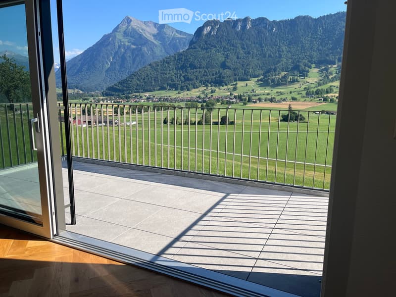 Balcony with tiled floor, metal railing, and scenic mountain view.
