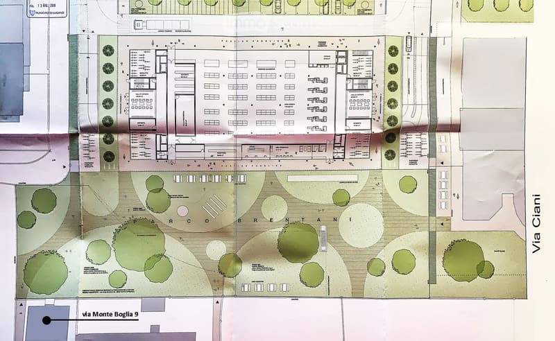 Floor plan of a residential complex with multiple apartments, common areas, and outdoor spaces. Includes labeled rooms such as living rooms, bedrooms, bathrooms, and a shared courtyard.