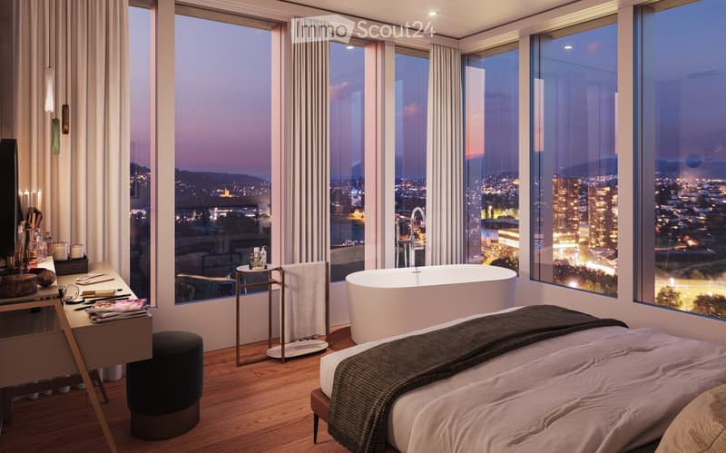 Modern bedroom with large windows offering a cityscape view, featuring a bed, bathtub, small table, and stool.