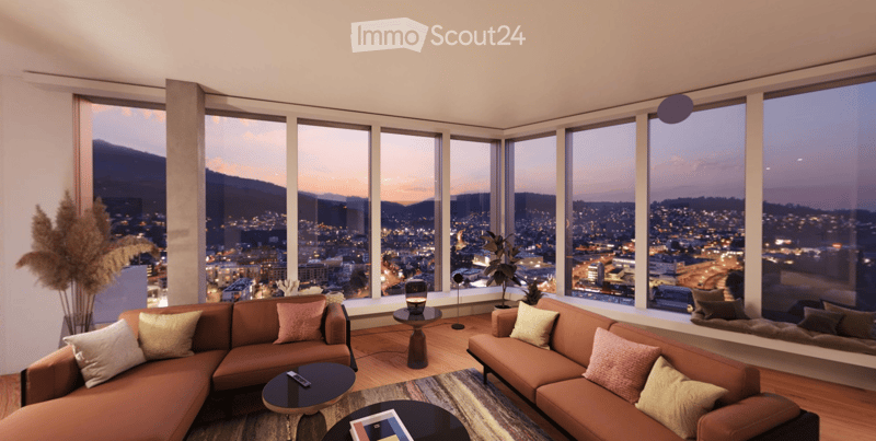 Modern living room with large windows offering a cityscape view, featuring a brown sectional sofa, coffee tables, table lamp, floor lamp, and a potted plant.