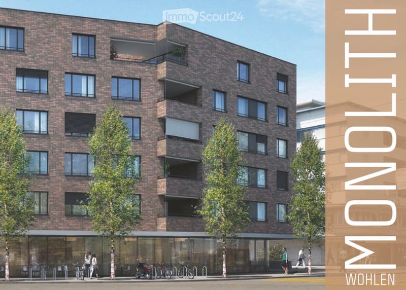 Modern multi-story brick building with large windows, balconies, and greenery around the base.