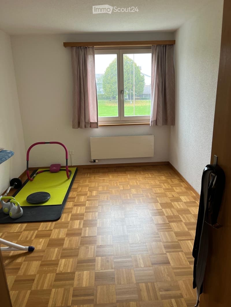 exercise room, exercise equipment, large window, parquet flooring, wall-mounted radiator