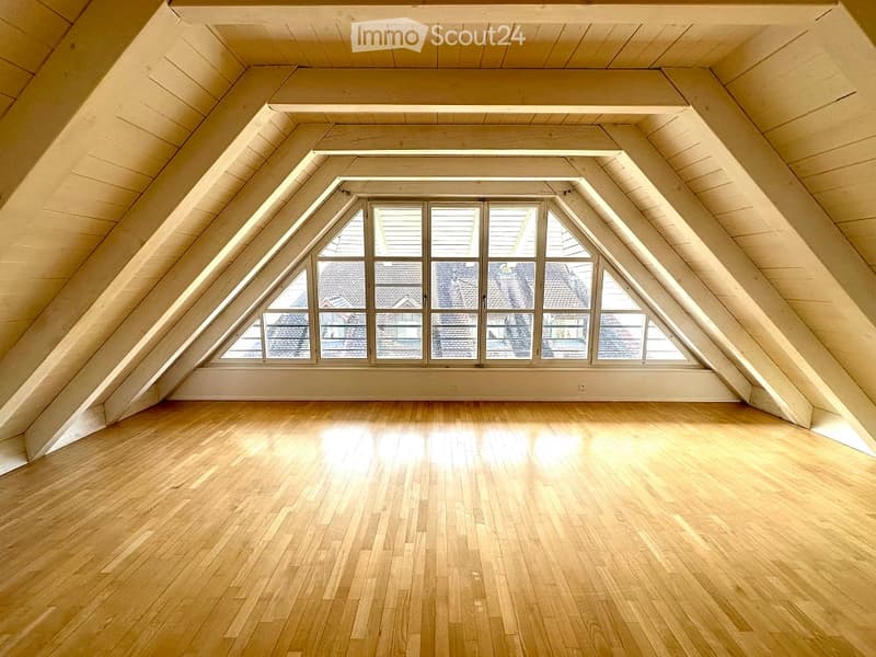 wooden floor, wooden beams, triangular window, white walls