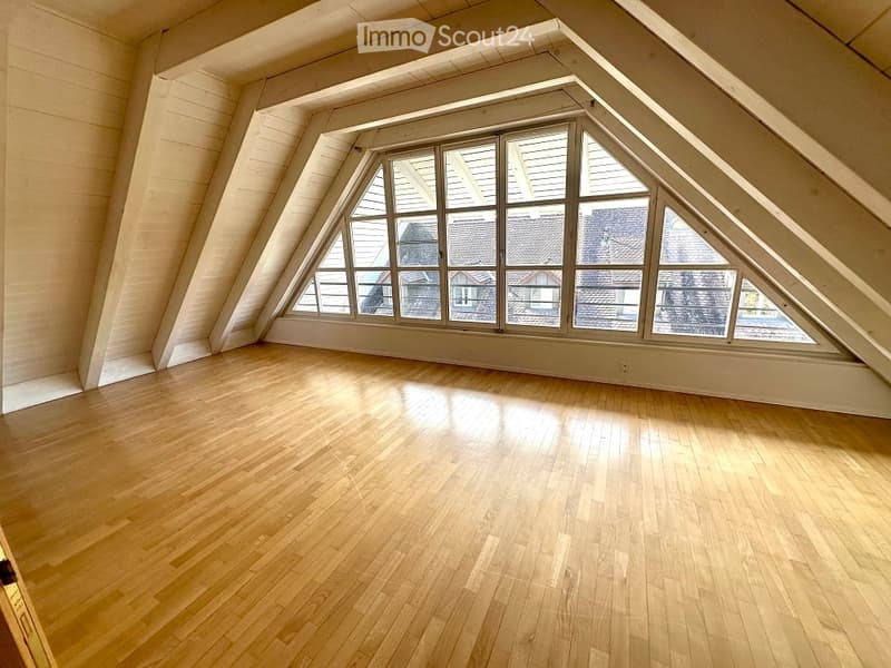 empty room, wooden floors, wooden beams, large triangular window