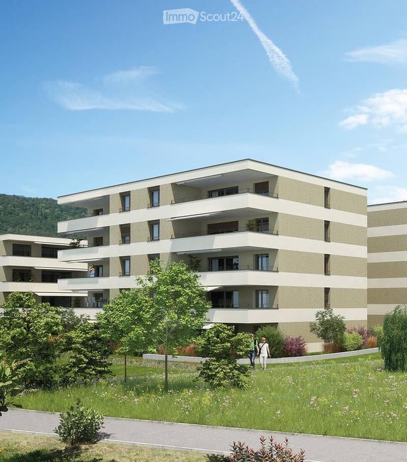 Modern multi-story residential building with balconies, surrounded by greenery and a well-maintained lawn.
