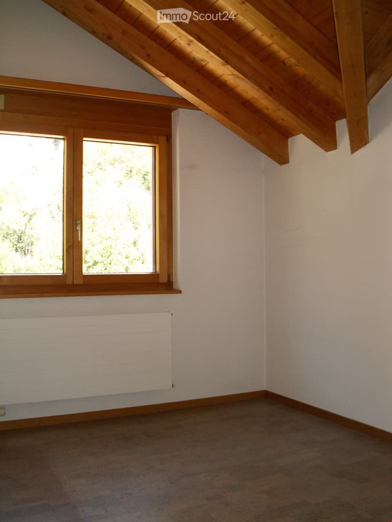room with window, wooden window frame, wooden ceiling, radiator, wooden floor