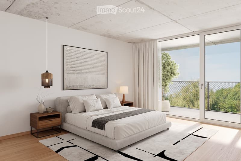 Modern bedroom with a large bed, nightstands, lamps, artwork, and a view of greenery through large windows.