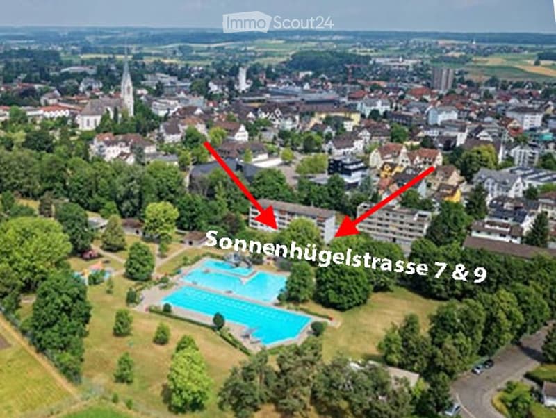 Aerial view of a residential area with two highlighted buildings labeled "Sonnenhügelstrasse 7 & 9" and a swimming pool in the foreground.