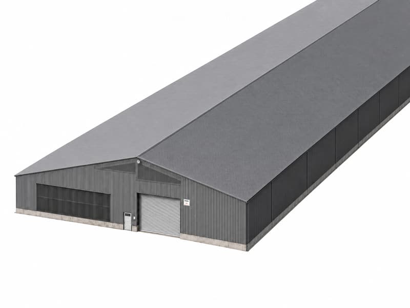 A modern industrial-style building with a grey metal exterior, large garage door, and a sloped roof.