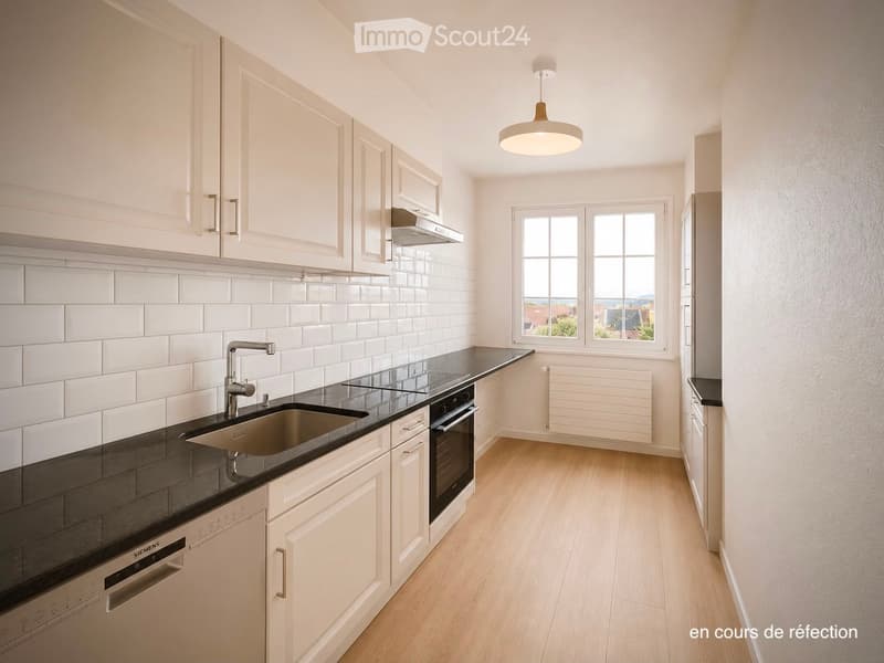Modern kitchen with white cabinets, black countertops, stainless steel sink, and built-in appliances.