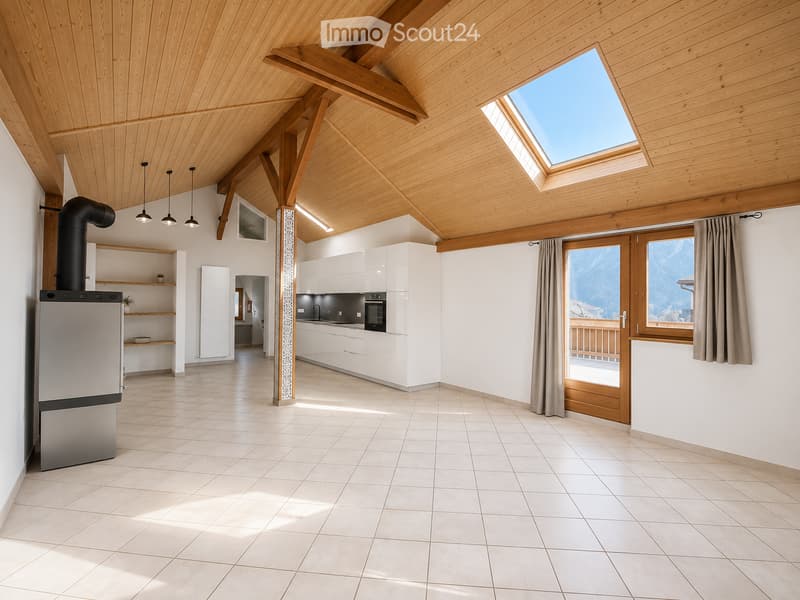 Bright, open room with white tiled flooring, wooden beams, skylight, and a view of mountains through large windows. Includes a refrigerator, oven, kitchen cabinets, and a sink.