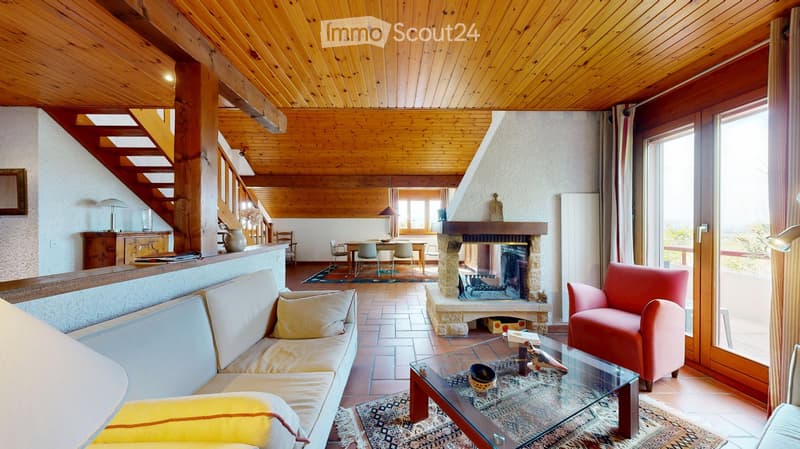 living room with a fireplace, couches, rug, coffee table, and large glass doors