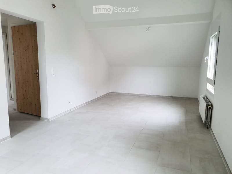 Empty room with white walls, tiled floor, and a single window. No furniture or equipment is present.