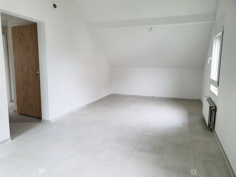 Empty room with white walls, tiled floor, and a single window. No furniture or equipment is present.