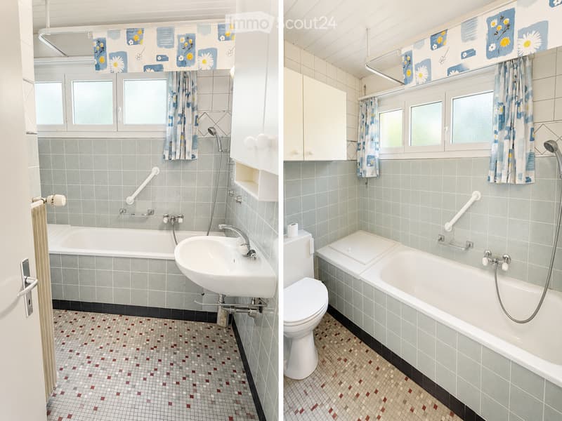 Two adjacent bathrooms with light blue tiled walls, mosaic tiled floors, bathtubs, sinks, and toilets. Both have handrails and floral curtains.