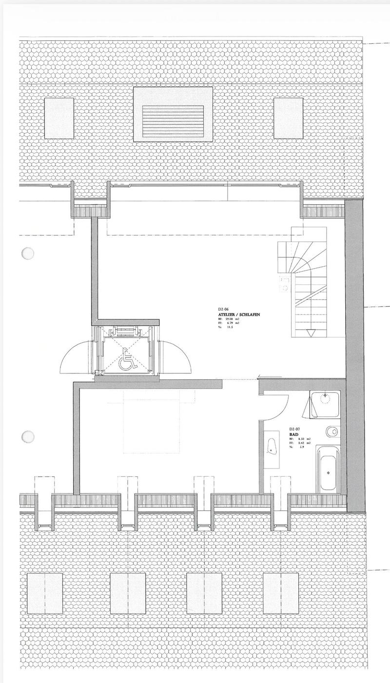 Floor plan showing an atelier/sleeping area and a bathroom. The layout includes a bed area, a wheelchair-accessible bathroom, and a separate shower area.