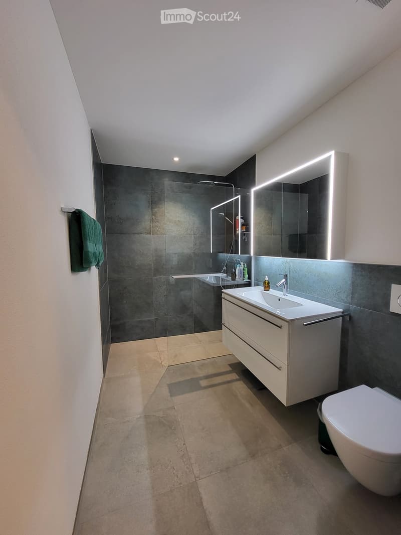 white bathroom with shower, modern sink, mirrors, towel rack, tiles, floor, and toilet