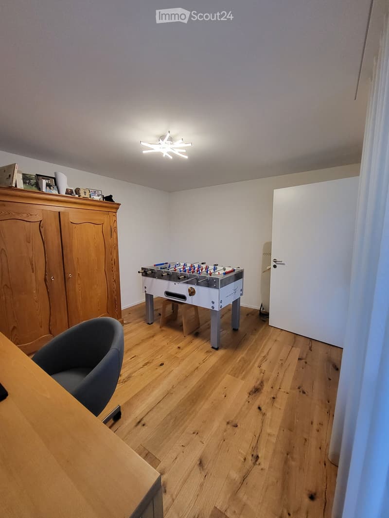 wooden floor, wooden cabinet, foosball table, wooden table, gray chair