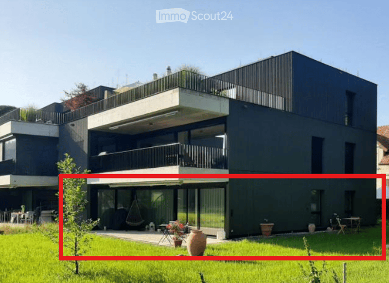 modern two-story house, black exterior, large windows, several balconies
