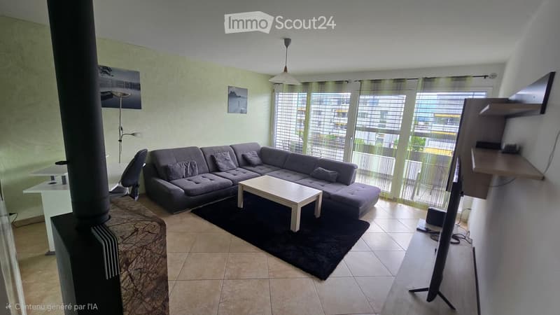 Modern living room with a grey sectional sofa, white coffee table, black rug, large windows with blinds, and a TV stand with a screen.