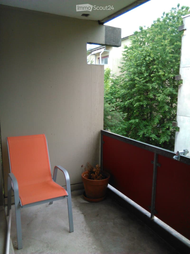 small balcony, orange chair, potted plant