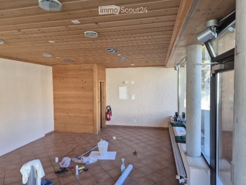 Empty room with wooden ceiling, tiled floor, and white walls. No furniture or equipment present.