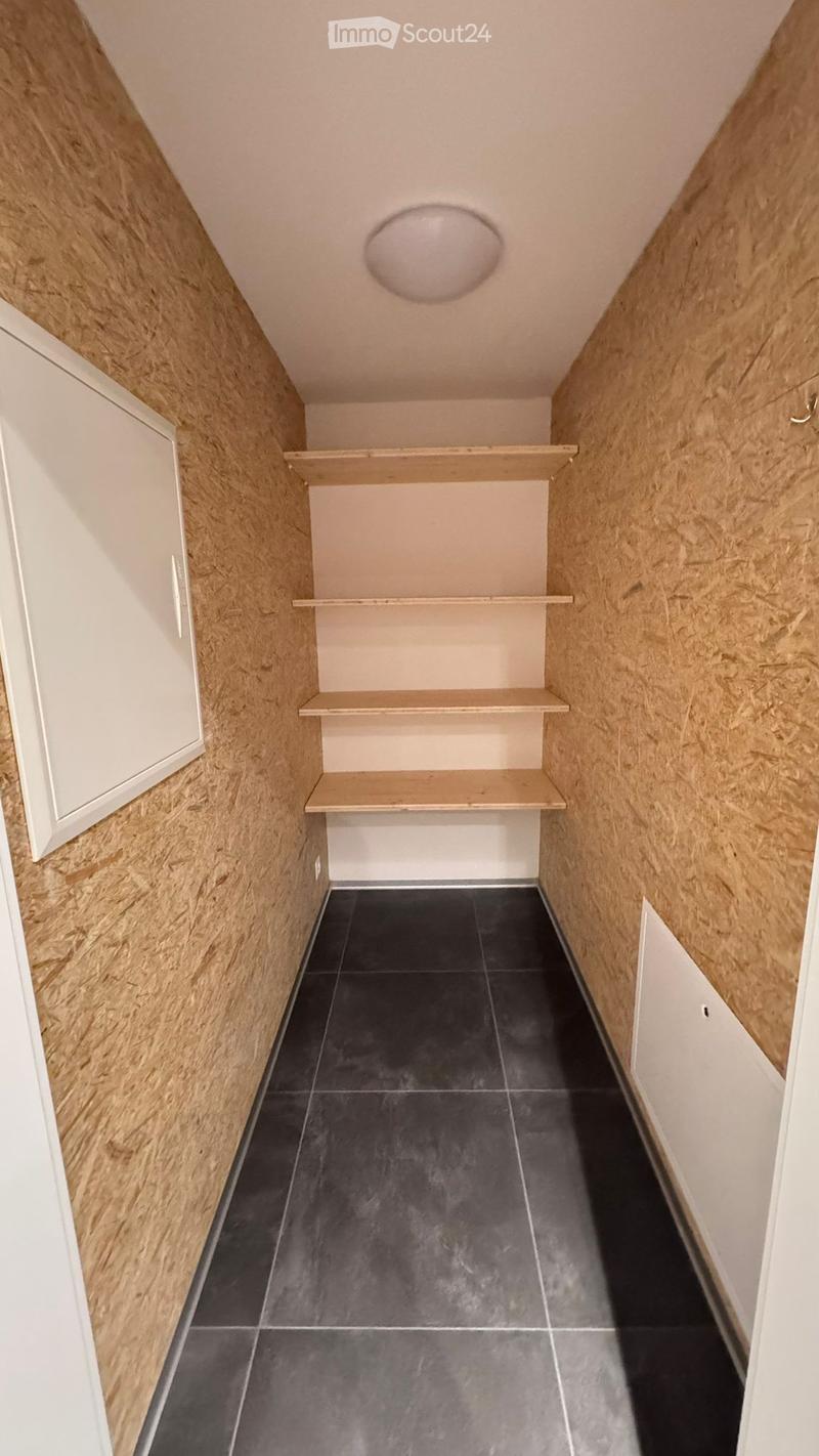 empty room, wooden shelves, tiled floor, white ceiling light
