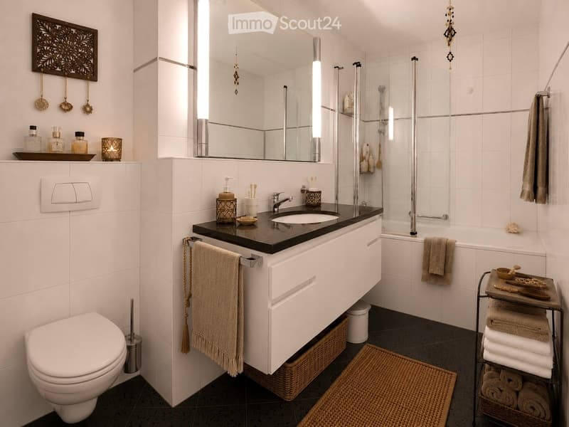 Modern bathroom with white tiles, a black countertop sink, a large mirror, a bathtub, and a toilet. Features include decorative towels, a wicker basket, a wicker mat, and various decorative items on shelves and surfaces.