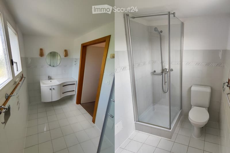 Modern bathroom with white tiles, a sink with a cabinet, a mirror, a glass-enclosed shower, and a toilet.