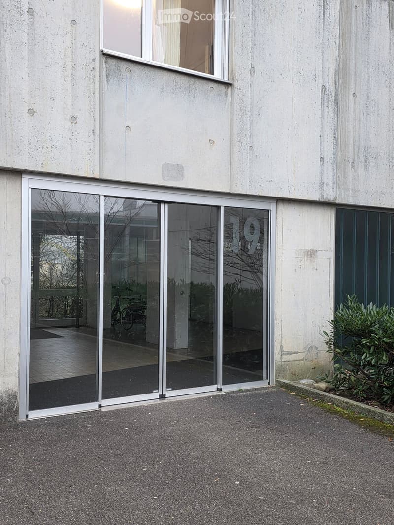 Concrete building with sliding glass doors, number 19 on the door