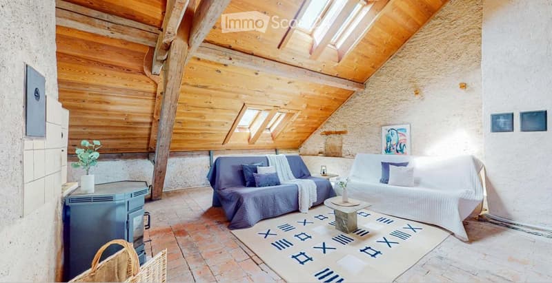 wooden ceiling, brick floor, two couches, coffee table, fireplace, rug, plant