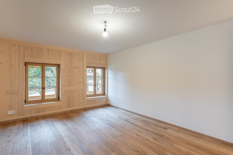 empty room with wooden walls, windows, floor, and ceiling