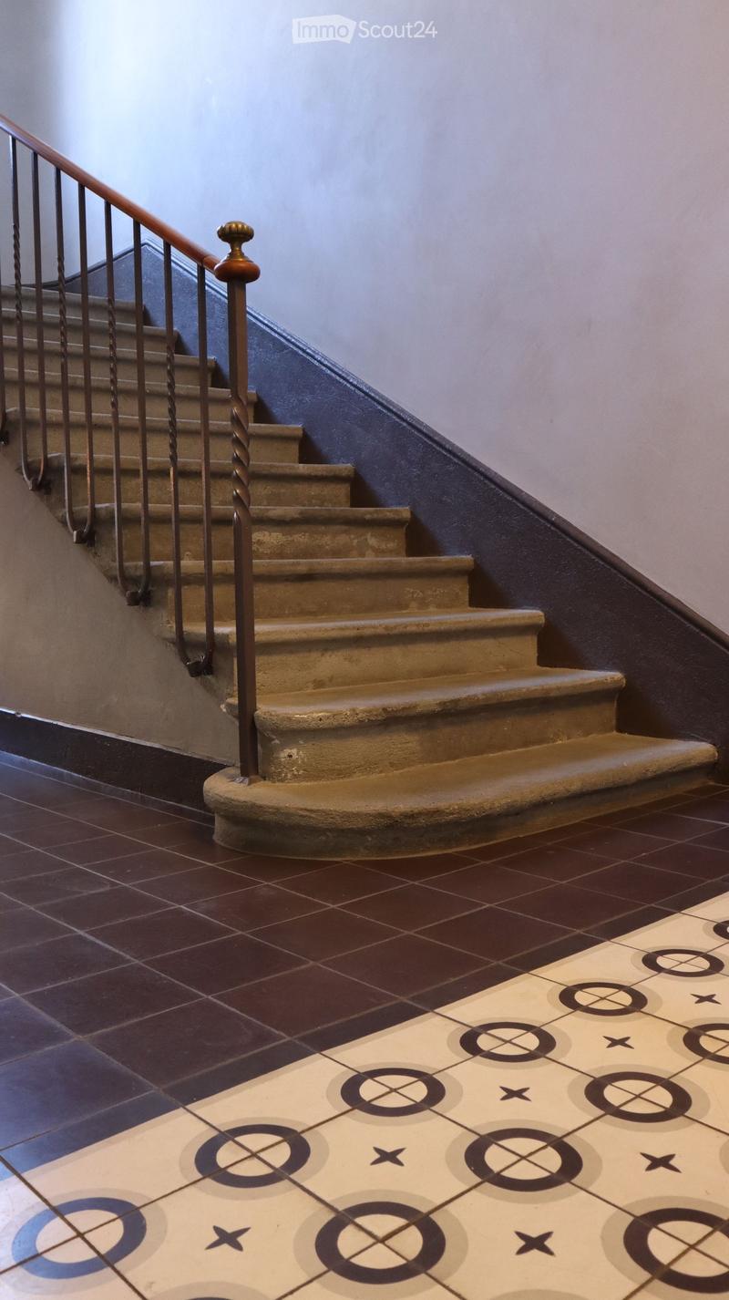 Stone steps, metal handrail, tiled wall