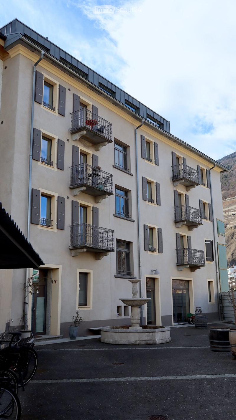 5 story building, balconies, fountain, bicycles parked
