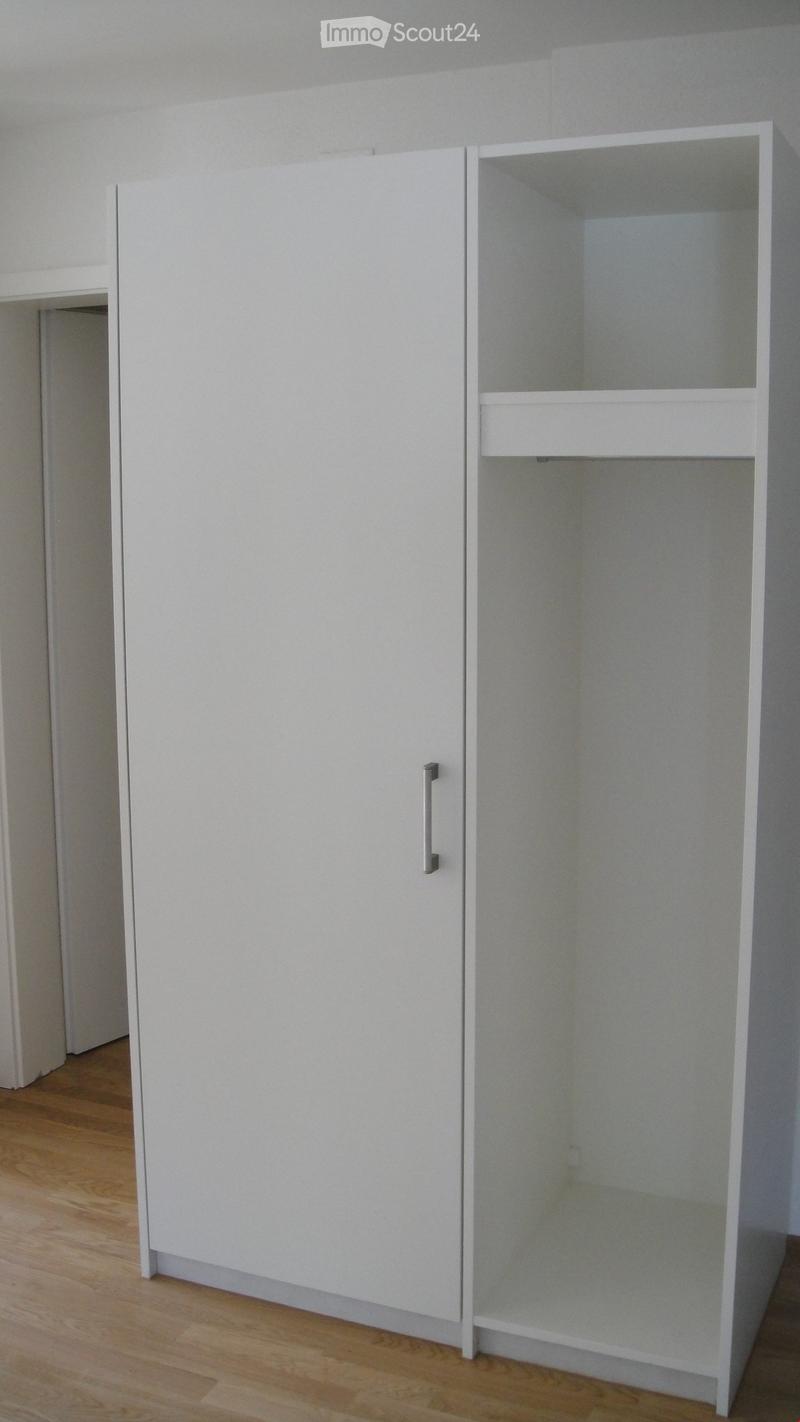 Empty room with white built-in closet and wooden floor. No furniture or personal items visible.
