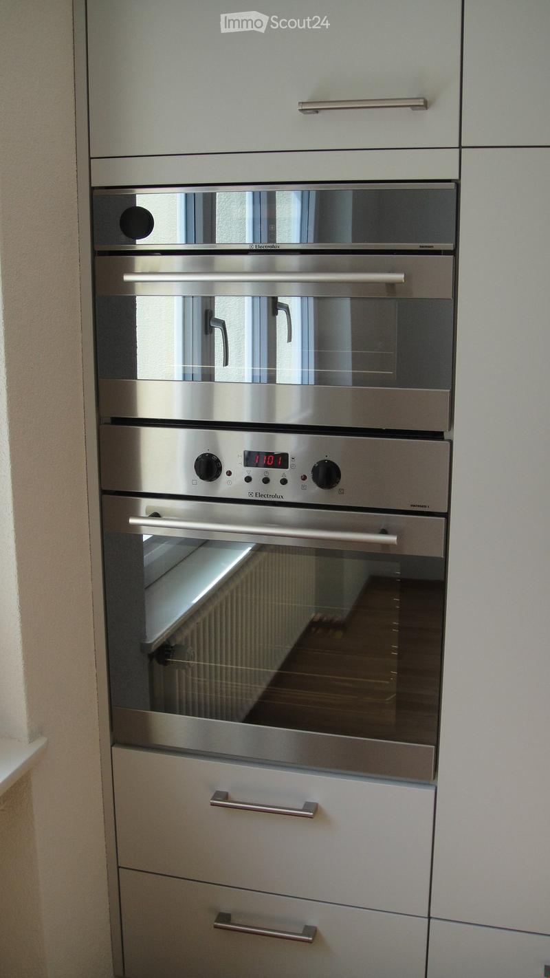 Modern kitchen with stainless steel oven and sleek cabinetry.