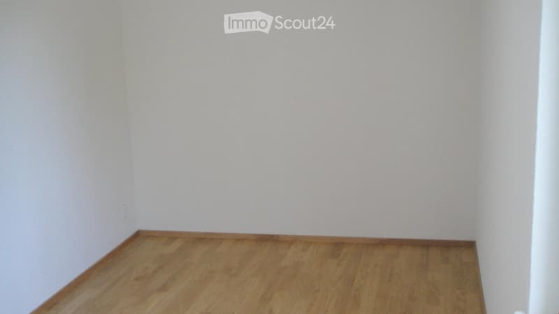 Completely empty room with bare walls and wooden floor. No furniture or equipment.