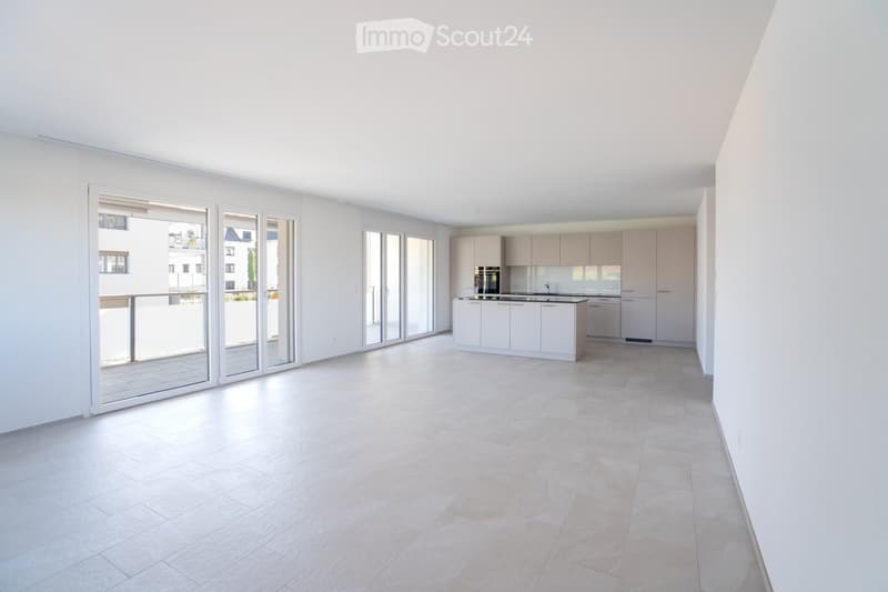 Modern, minimalist kitchen with white cabinets, a central island, and large glass sliding doors leading to a balcony.