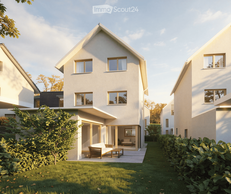 Modern two-story house with white exterior, large windows, and a raised ground floor. The house features a small patio area with a sofa and coffee table, surrounded by greenery and a well-maintained lawn.