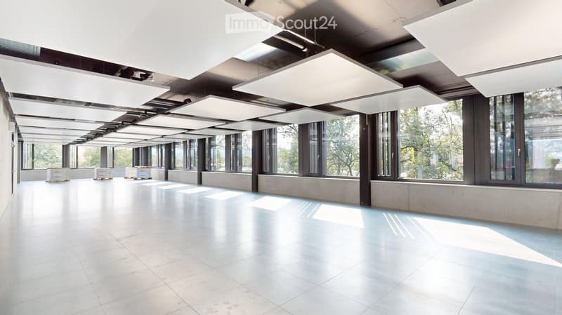 Empty room with white tiled floor, large windows, and modern ceiling lights. No furniture or equipment present.