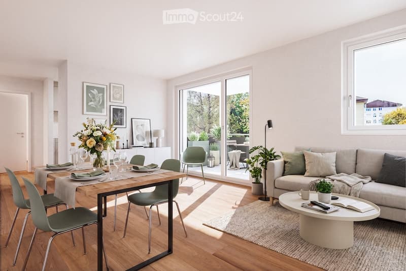 Bright, modern living and dining area with large windows and a view. Features a light-colored sofa, coffee table, dining table with chairs, and decorative elements like a vase with flowers and artwork on the walls.