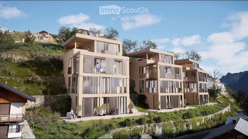 Modern multi-story residential building with large windows and balconies, situated on a hillside with surrounding greenery and mountains in the background.