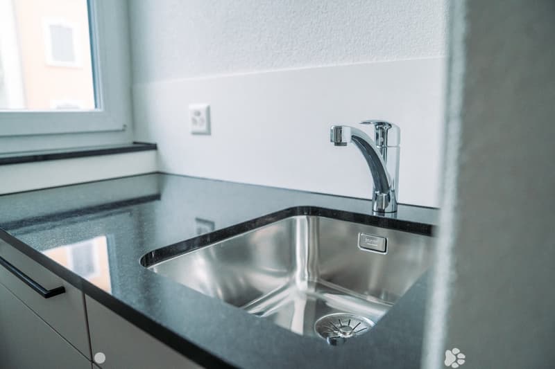 Stainless steel sink, countertop, window, stainless steel faucet, kitchen cabinets, power outlet