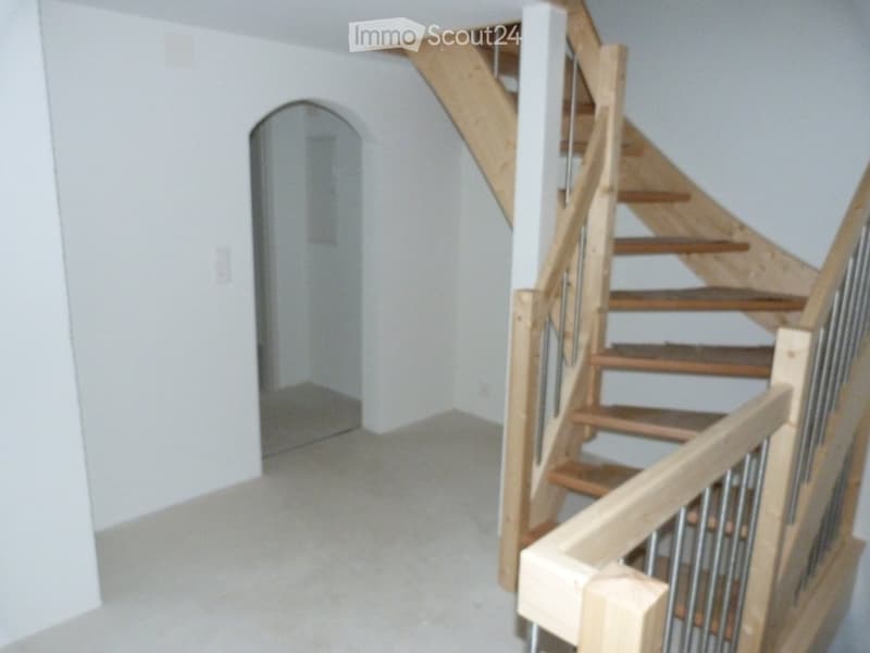 Empty room with wooden staircase
