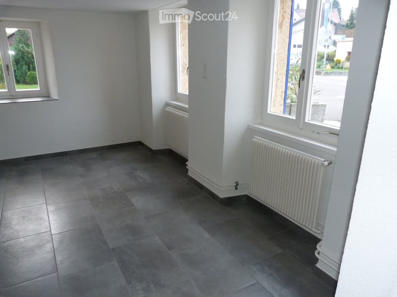 empty room, white walls, tiled floor, two windows with white frames