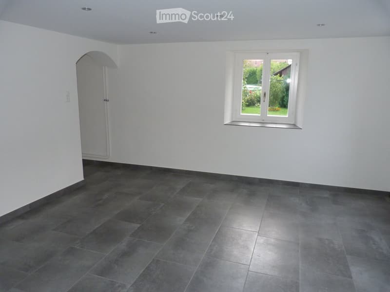 empty room, gray tile floor, white walls, arch doorway, small window