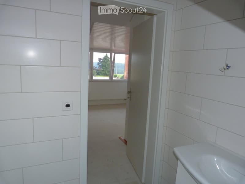 tiled walls, floor, sink, large window