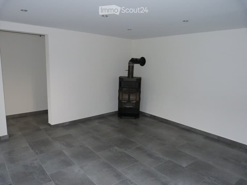 empty room, gray tiles, white walls, fireplace, sliding door, recessed lighting