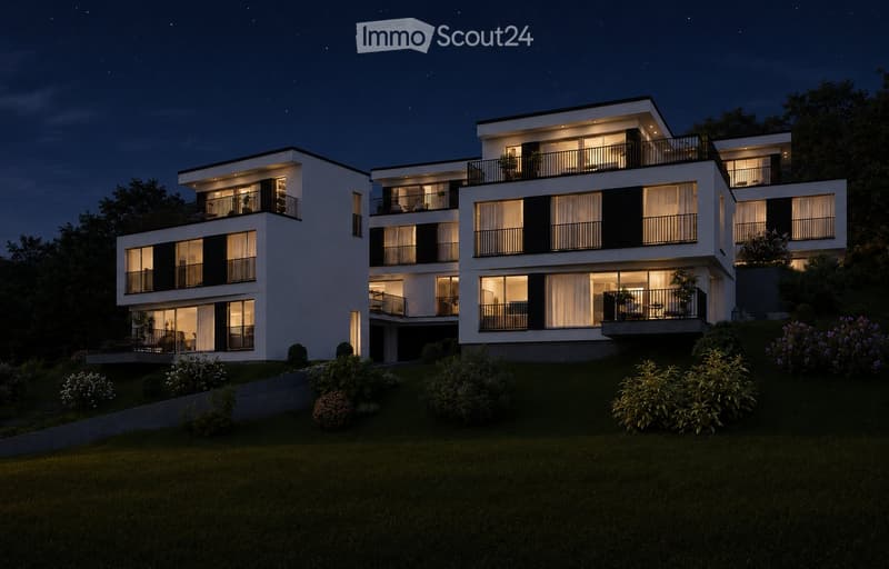 Modern three-story house with white exterior, black accents, multiple balconies, and well-lit windows. The house is surrounded by a landscaped garden with shrubs and trees.
