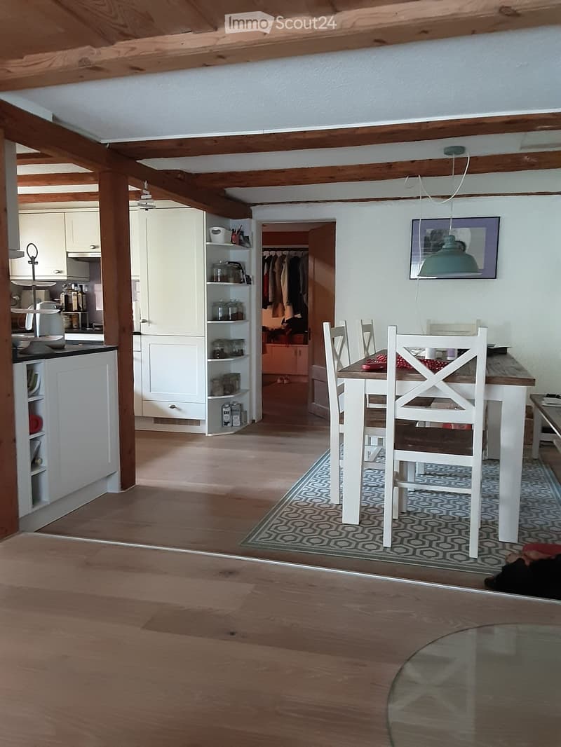 {"type": "Furnished Room", "objects": ["dining table", "chair", "kitchen cabinet", "cupboard", "shelf", "faucet", "bottle", "cup", "bottle", "bottle", "bottle", "bottle", "bottle", "bottle", "bottle", "bottle", "bottle", "bottle", "bottle", "bottle", "bot